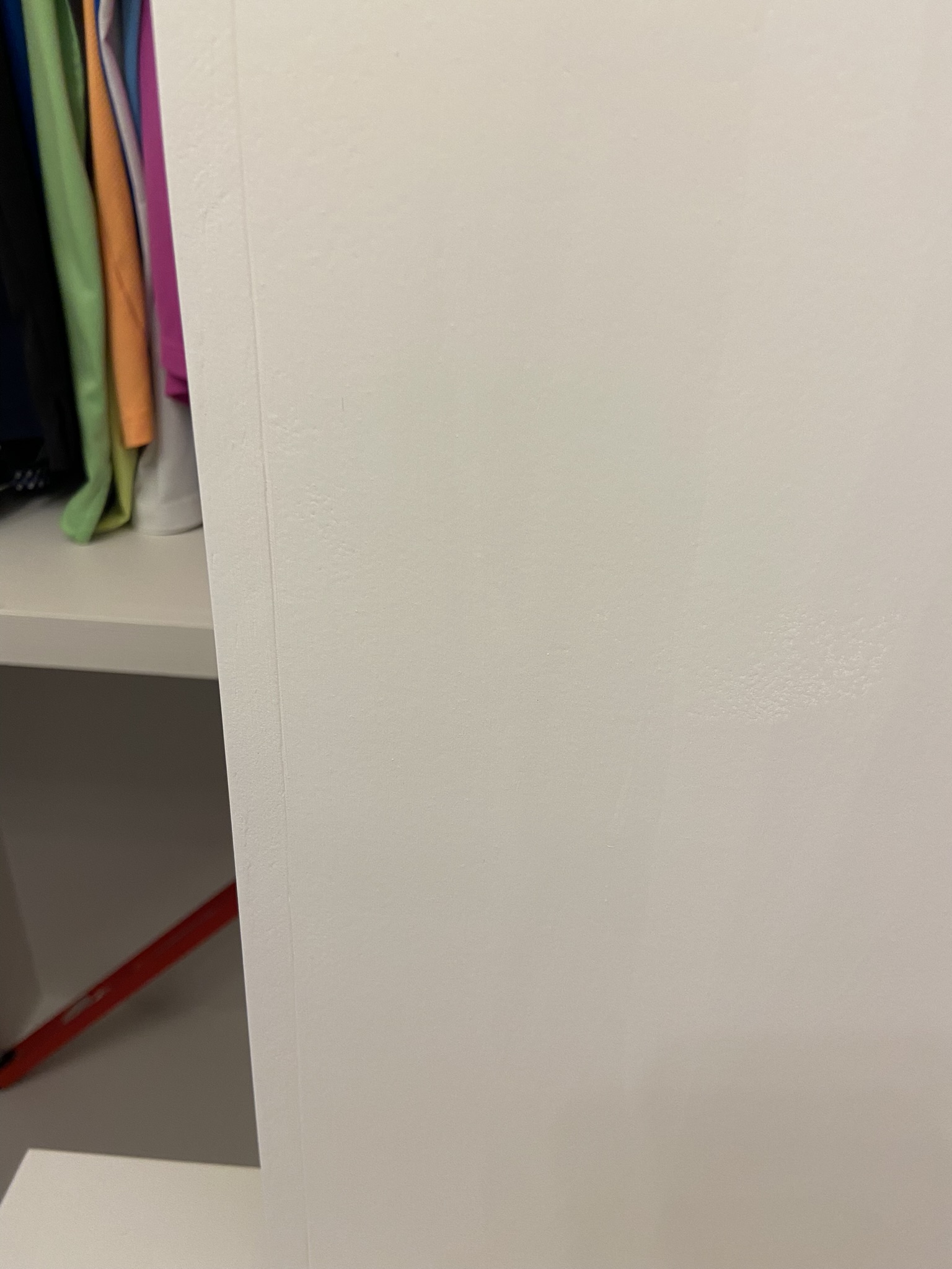 DIY Custom closet makeover, filling wood seams with spackle.