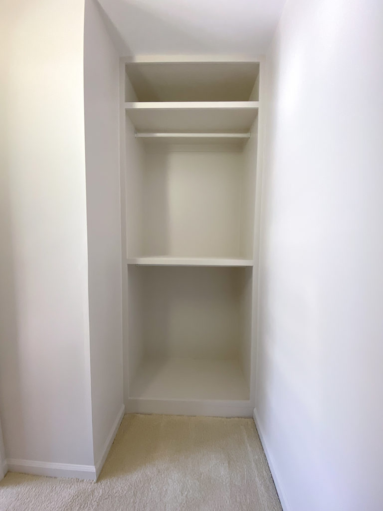Custom Walk-in Closet Built ins, painted in creamy white.