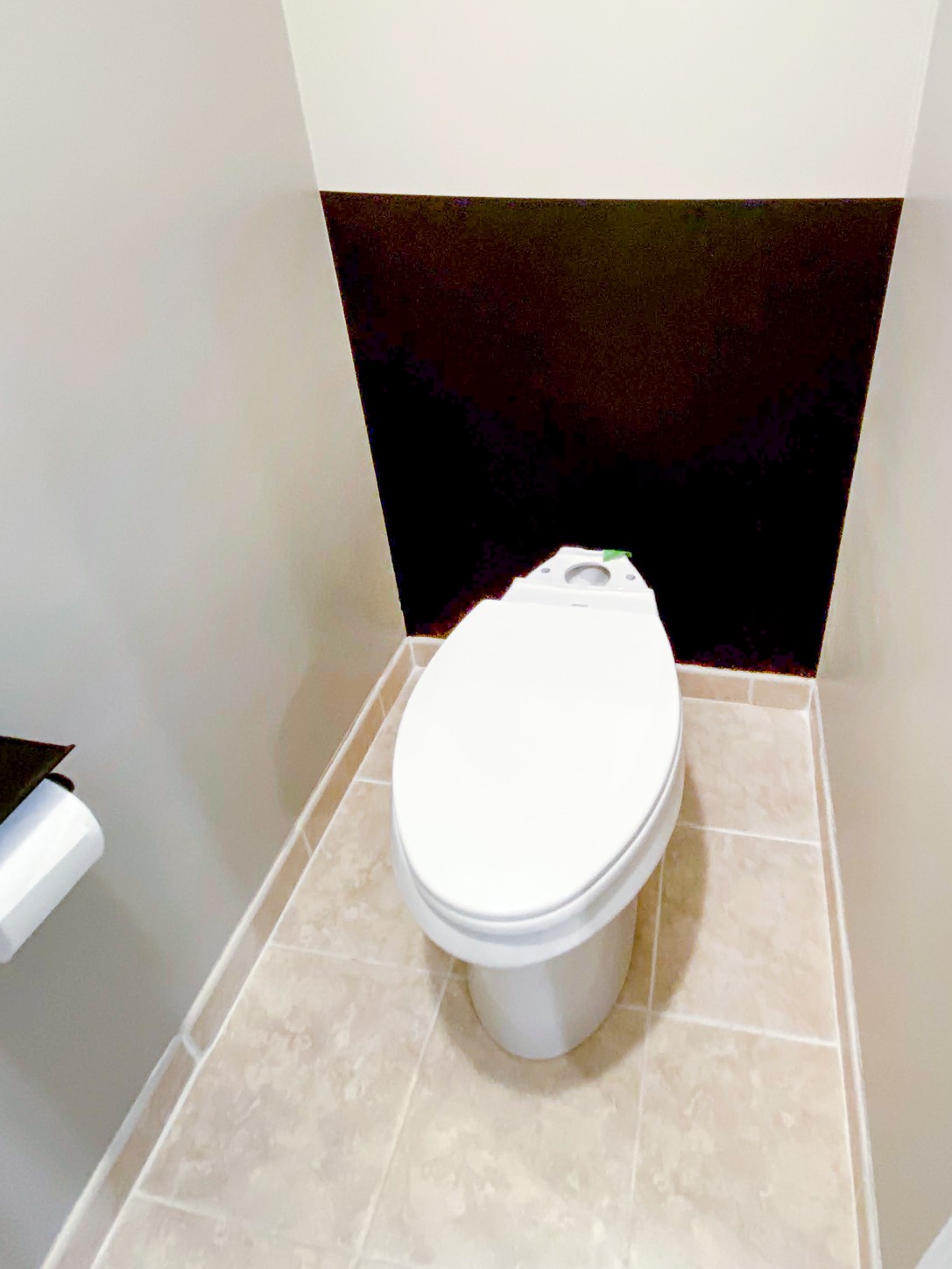 small water closet with black color-blocked paint.