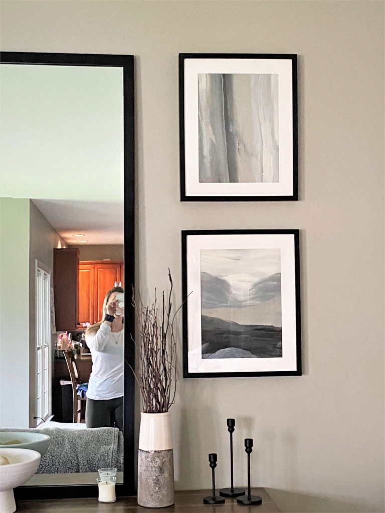 Neutral DIY Abstract Art with sleek, black frames on the wall of a living room.