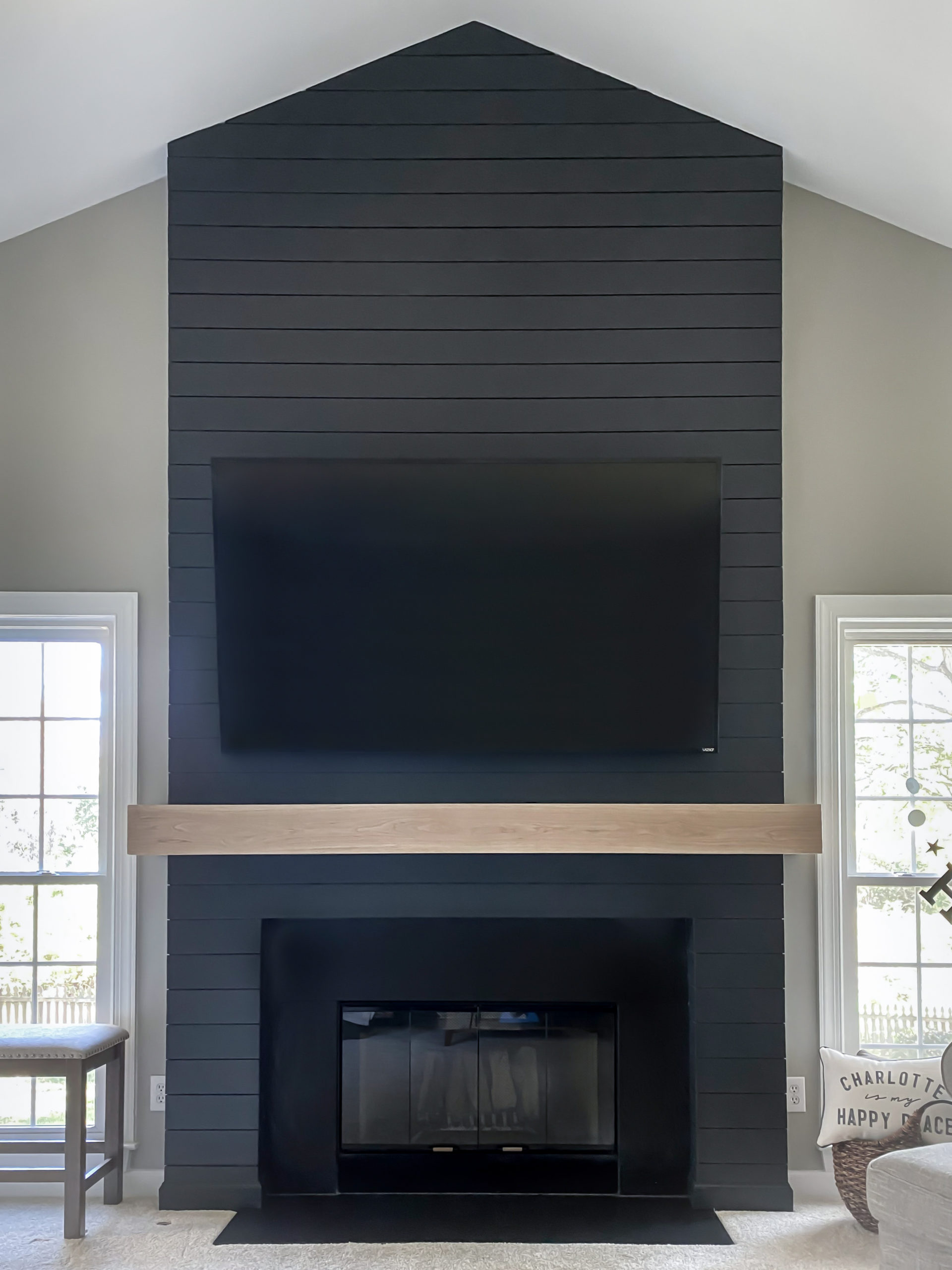 DIY Modern Shiplap Fireplace painted in a dark blue with a white oak mantel.
